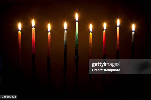 hanukkah menorah candles lit on black background  - menorah lights stock pictures, royalty-free photos & images