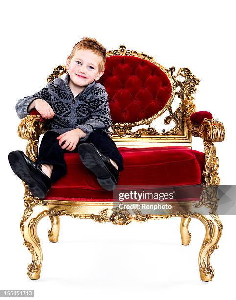 cute little boy sitting on a throne chair - throne stock pictures, royalty-free photos & images