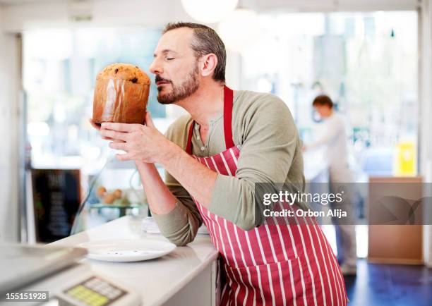 chef smelling christmas panettone - chef smelling food stockfoto's en -beelden
