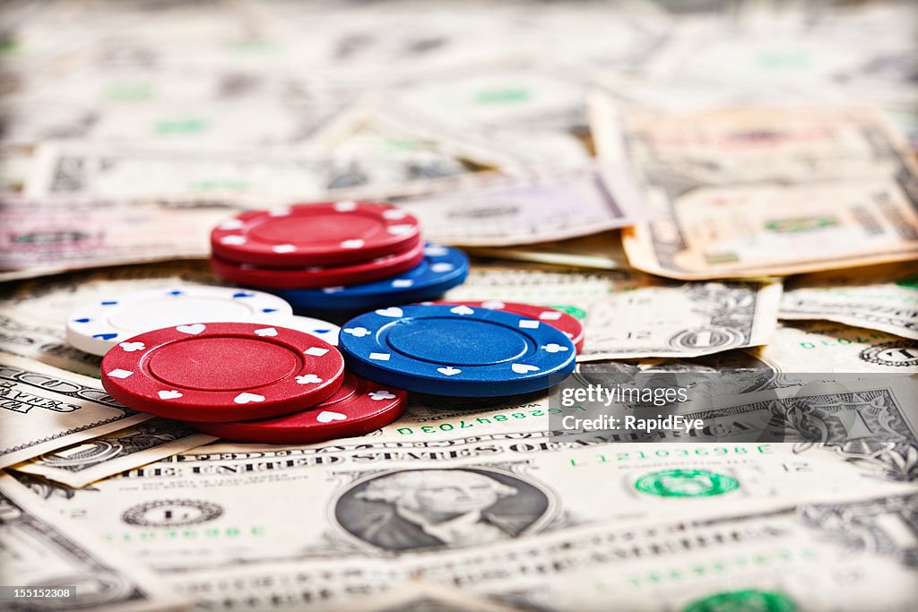 The cost of gambling: chips on infinite dollar background
