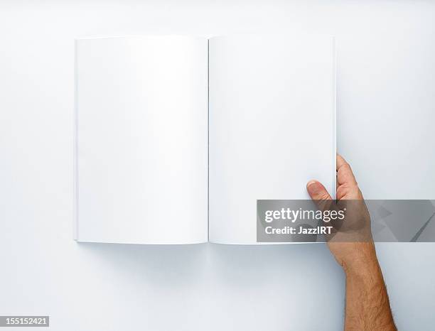 hand holding open a blank magazine - blank pages in open book overhead view stock pictures, royalty-free photos & images