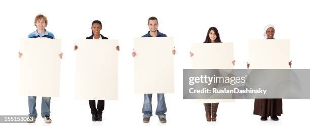 multi ethnic group holding a sign. - man holding paper stock pictures, royalty-free photos & images