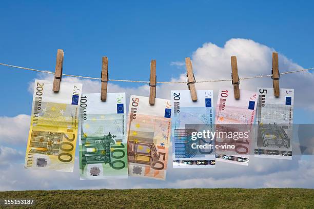 wet euro banknotes hanging on a clothes line - clothesline stock pictures, royalty-free photos & images