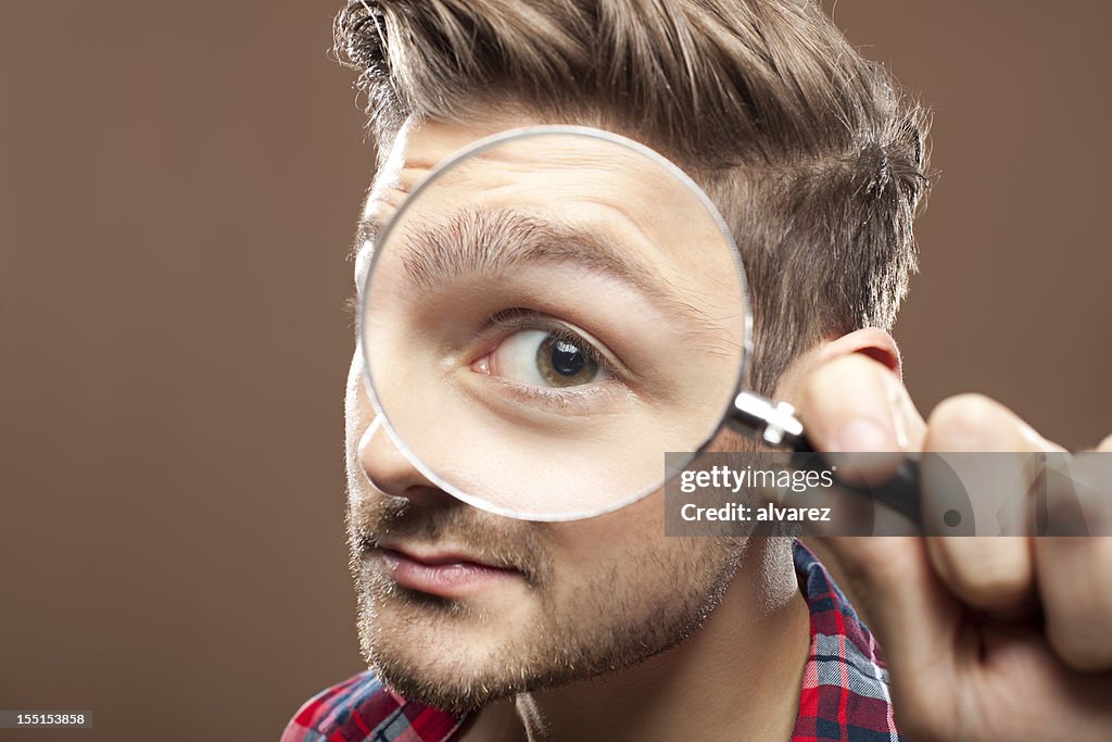 Portrait of a man with magnifying glass