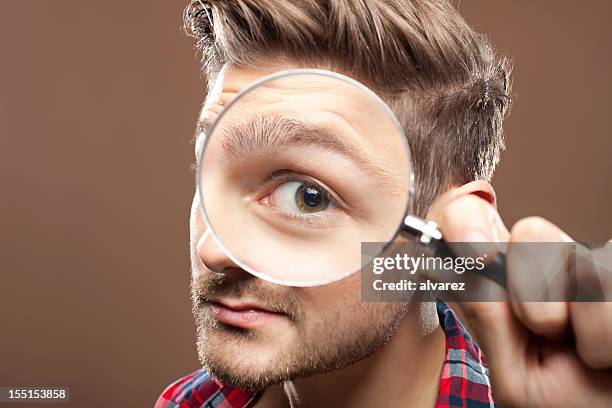 portrait of a man with magnifying glass - lupe stock pictures, royalty-free photos & images