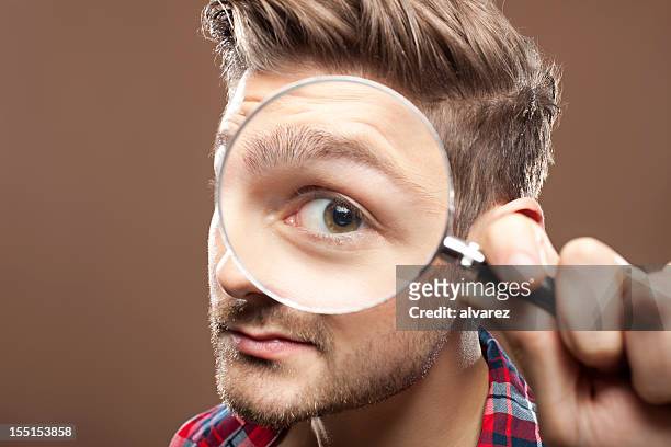 portrait of a man with magnifying glass - loupe bildbanksfoton och bilder