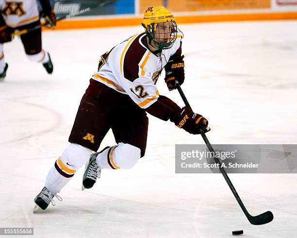 Justin Holl of the University of Minnesota carries the puck in a game against the United States U-18 team October 26, 2012 at Mariucci Arena in...