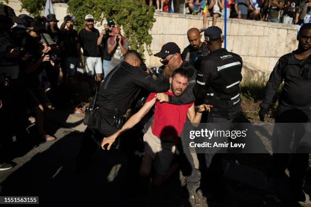 Police officers clash with protesters as they evacuate protesters from a main road on July 24, 2023 in Jerusalem, Israel. Some 20, 000...