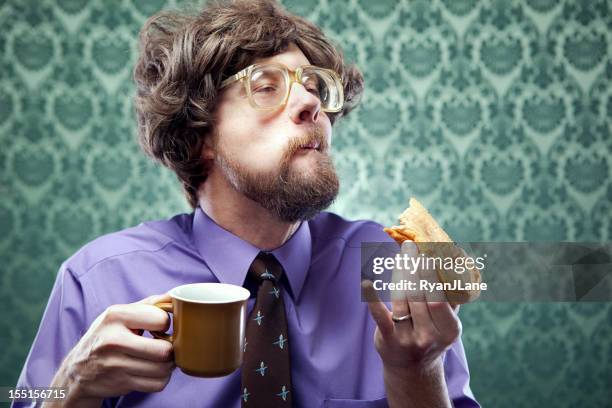 office nerd eating donut with coffee - donut man bildbanksfoton och bilder