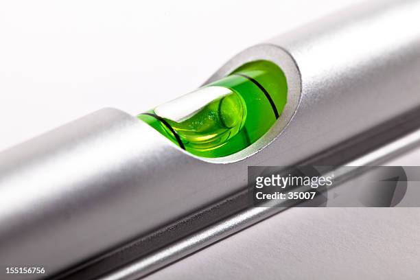 the center liquid area of a silver level - spirit level stock pictures, royalty-free photos & images