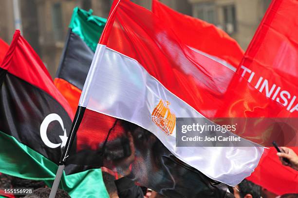 flags of libya, egypt, and tunisia (tahrir square, cairo, egypt) - arab spring 2011 stock pictures, royalty-free photos & images