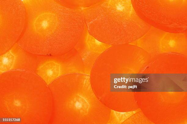 carrot cross sections makes an orange background - pejft stock pictures, royalty-free photos & images