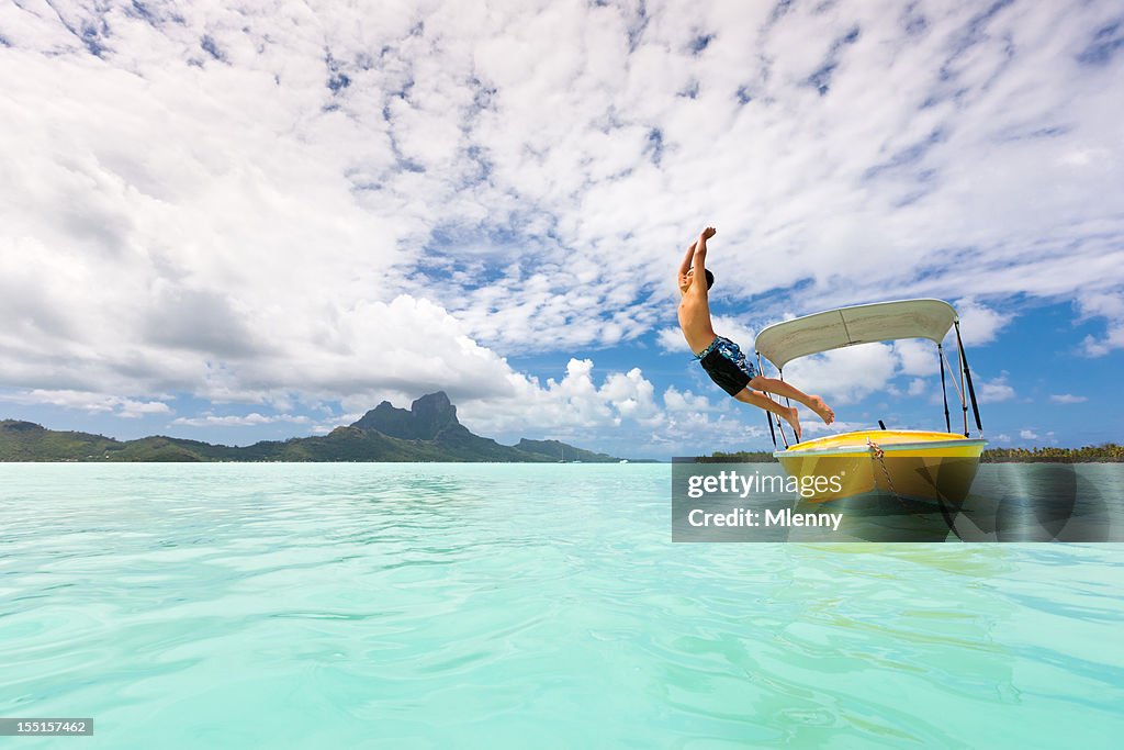 Holidays in Paradise Boy Jumping into Bora-Bora Lagoon