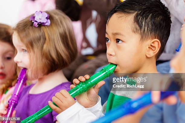 preschool children in a music class - recorder stock pictures, royalty-free photos & images