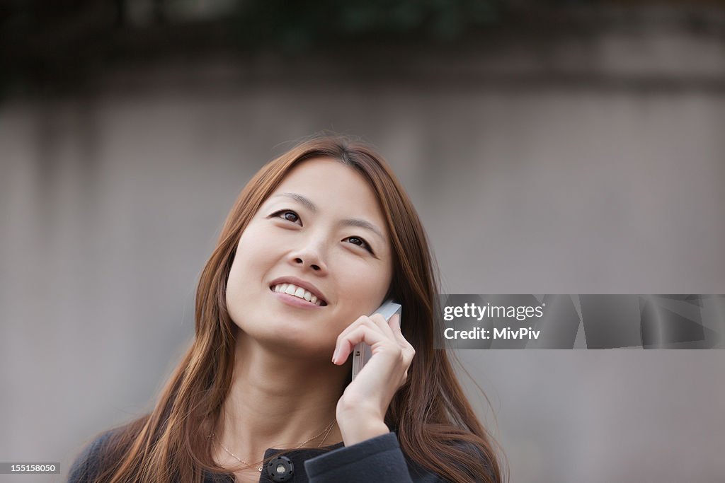 Urban Japanese Businesswoman talking on the phone