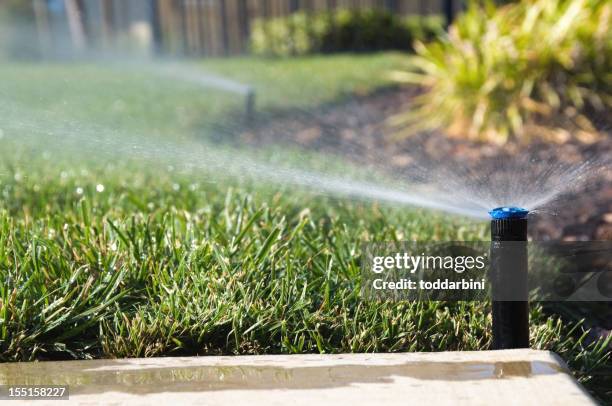 lawn sprinklers - agricultural sprinkler stock pictures, royalty-free photos & images