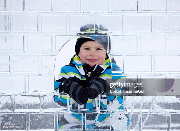 caucasian boy looking through ice sculpture - isskulptur bildbanksfoton och bilder