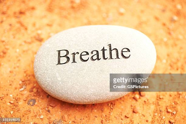 rock with breathe written on it. - relaxation therapy stock pictures, royalty-free photos & images