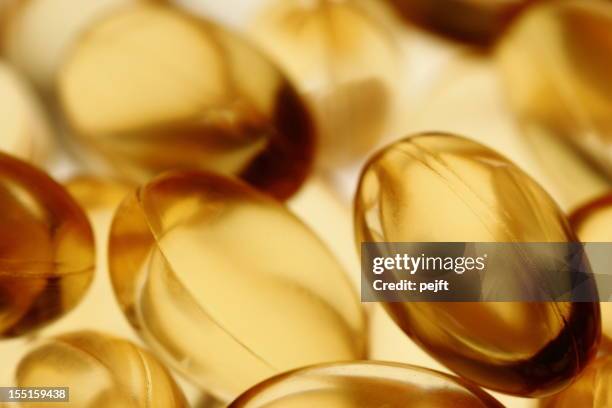 golden gel vitamin omega-3 fish oil capsules - pejft stock pictures, royalty-free photos & images