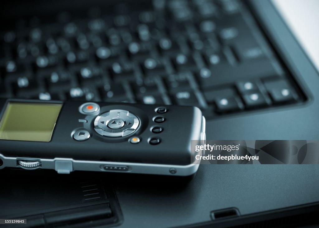 Digital Voice Recorder lying on laptop