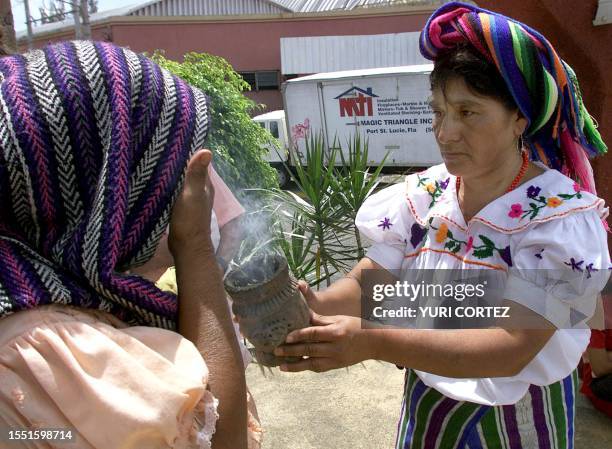 An indigenous woman makes a purification rite with incense, 12 October 2000, during an act of protest for the celelbration of the Day of the Race and...