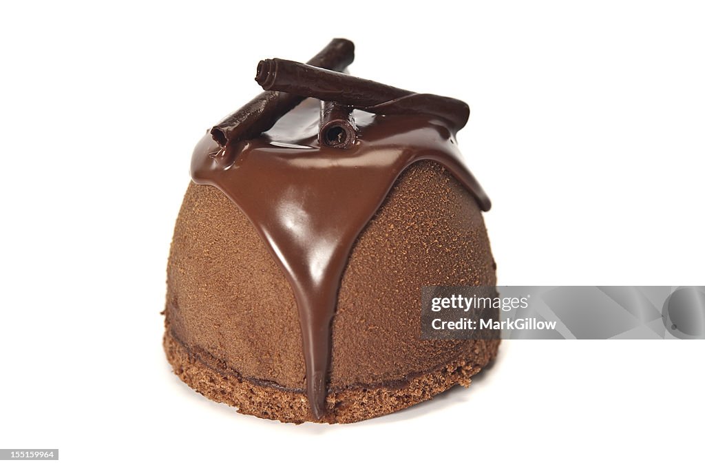 Chocolate mousse bomb desert over a white background