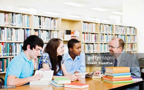 informal seminar with three students and teacher in library - rea001 stock pictures, royalty-free photos & images