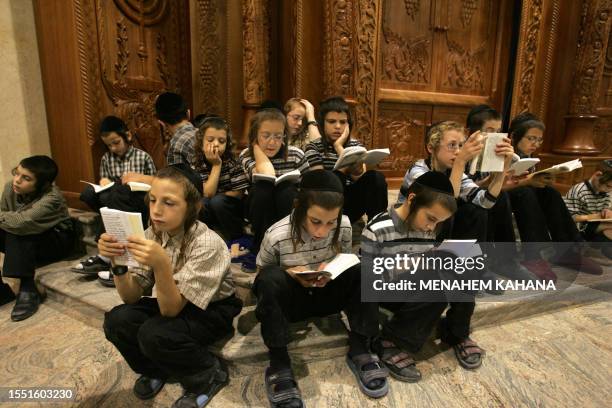 Religious Jews from the Brastlav sect read from the book of Eicha during the annual 9th of Av memorial for the destruction of ancient Jerusalem in...