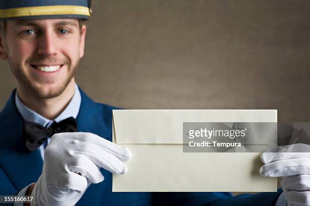 bellboy holding an envelope as copy space. - comic strip bildbanksfoton och bilder