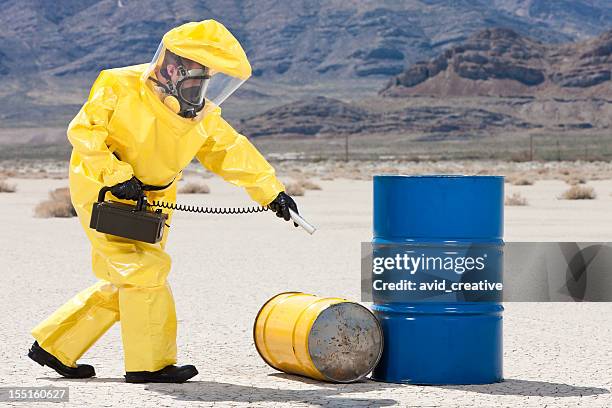 hazmat checking for radioactive leaks - protective suit stock pictures, royalty-free photos & images