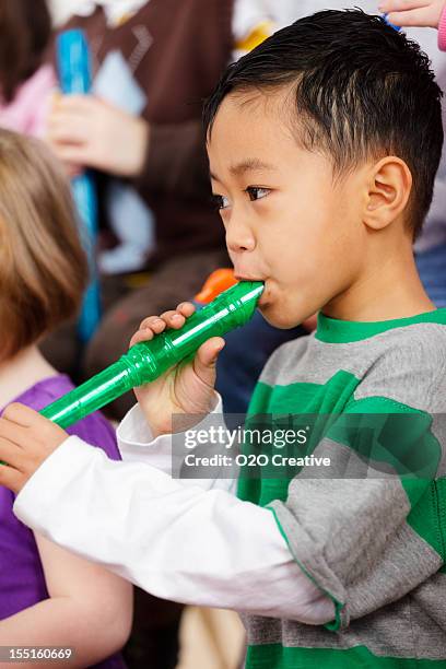 bébés enfants dans la classe de musique - flûte à bec photos et images de collection
