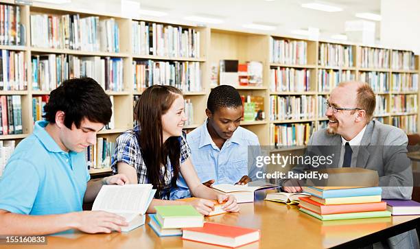 three students and professor in study session at library - rea001 stock pictures, royalty-free photos & images