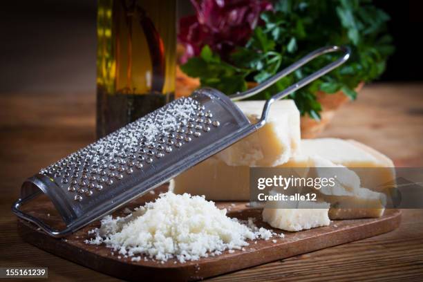 parmesan cheese with grater - grated stock pictures, royalty-free photos & images