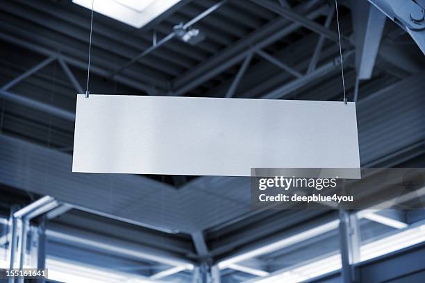 hanging metal billboard in business room - hangen stockfoto's en -beelden