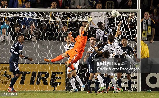 Edson Buddle of the Los Angeles Galaxy tries for the header as goalkeeper Brad Knighton of the Vancouver Whitecaps defends his net during the MLS...