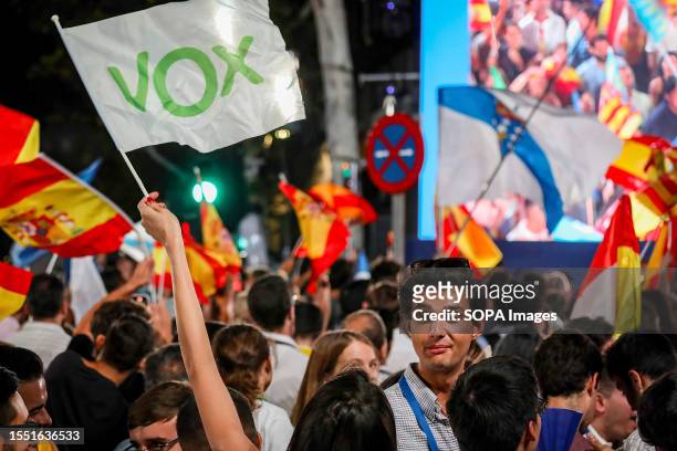 Supporter of the far-right party, VOX, celebrates among supporters of the Popular Party at the PP headquarters. Dozens of people gather at Calle...