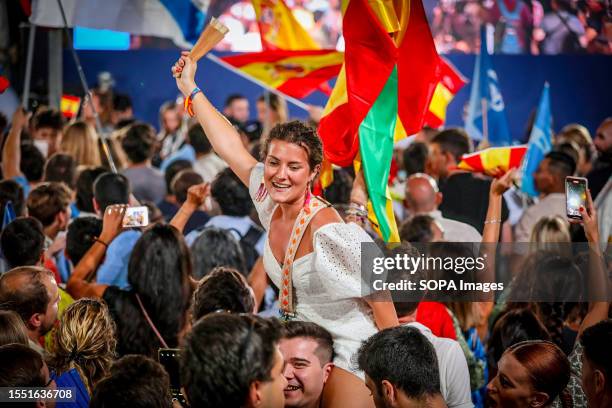 Supporter of the Popular Party celebrates the victory of her party at the PP headquarters. Dozens of people gather at Calle Génova 13 at the gates of...