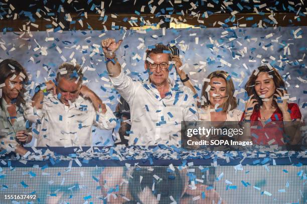 Alberto Nuñez Feijoo, candidate for the presidency for the Popular Party, greets his supporters from the balcony of his party headquarters while...