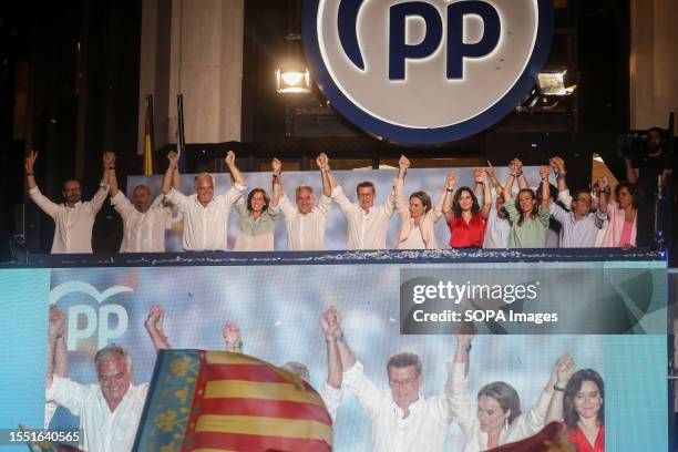 The top staff of the Spanish Popular Party greets its supporters from the balcony of the headquarters at the end of election night. Dozens of people...