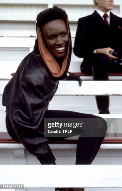 Jamaican-American model Grace Jones, is May Day, dressed in costume, sits in the stands at Royal Ascot Racecourse during the filming of the 1985...