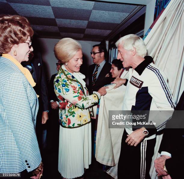 English disc jockey and television presenter Jimmy Savile meets the Duchess of Kent in Jersey, November 1980.