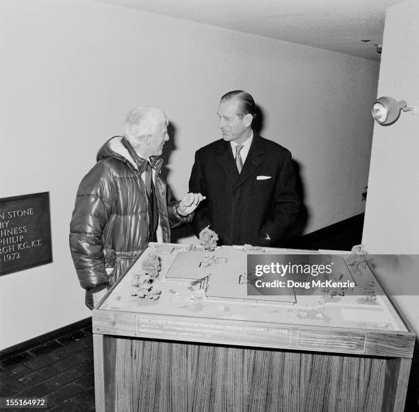 English disc jockey and television presenter Jimmy Savile and the Duke of Edinburgh with an architectural model of the Stoke Mandeville National...