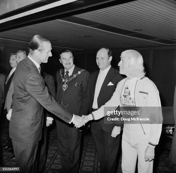 English television presenter Jimmy Savile meets the Duke of Edinburgh during a Variety Club of Great Britain charity walk luncheon, 19th April 1973.