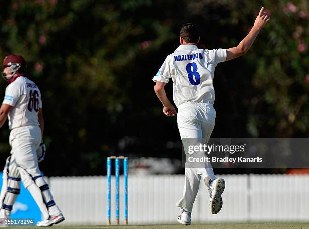 Josh Hazlewood of the Blues takes the wicket of Peter Forrest of the Bulls during day one of the Sheffield Shield match between the Queensland Bulls...