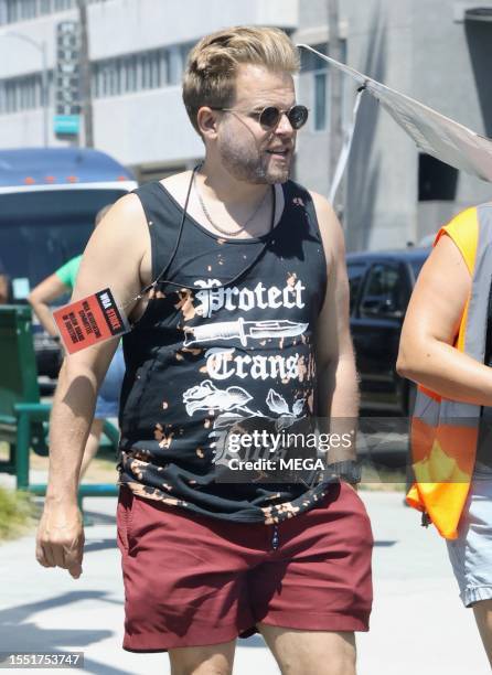 Adam Conover is seen picketing with SAG-AFTRA and WGA members outside of Netlifx studios on July 24, 2023 in Los Angeles, California.