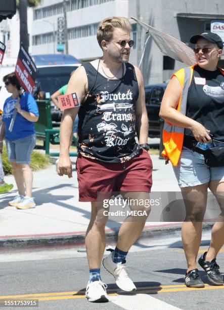 Adam Conover is seen picketing with SAG-AFTRA and WGA members outside of Netlifx studios on July 24, 2023 in Los Angeles, California.