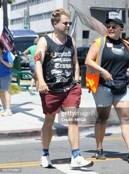 Adam Conover is seen picketing with SAG-AFTRA and WGA members outside of Netlifx studios on July 24, 2023 in Los Angeles, California.