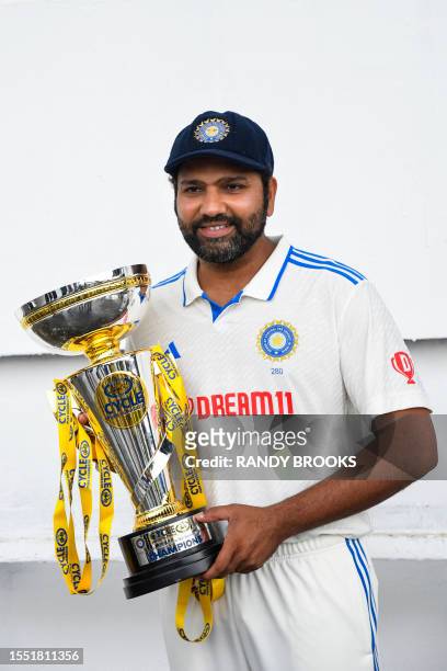 Rohit Sharma, of India, holds the winner's trophy at the end of the fifth and final day of the second Test cricket match between India and West...
