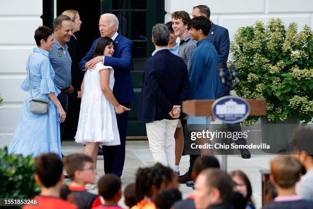 President Joe Biden embraces Philadelphia Union Co-President Robert Buccini's family as he drops in on first lady Jill Biden's youth soccer clinic...