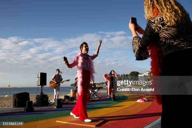 People take photos as a Harry Styles wax figure is unveiled on Coogee Beach on July 18, 2023 in Sydney, Australia.